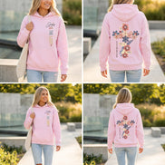 A pink pullover hoodie shown on a model from both the front and back. The front features the text 'Jesus IS THE LIGHT' in black, blue, and gold.