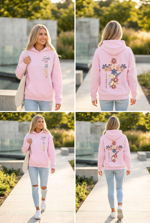 A pink pullover hoodie shown on a model from both the front and back. The front features the text 'Jesus IS THE LIGHT' in black, blue, and gold.
