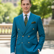 Blue suit jacket with gold buttons and matching pants on a white background
