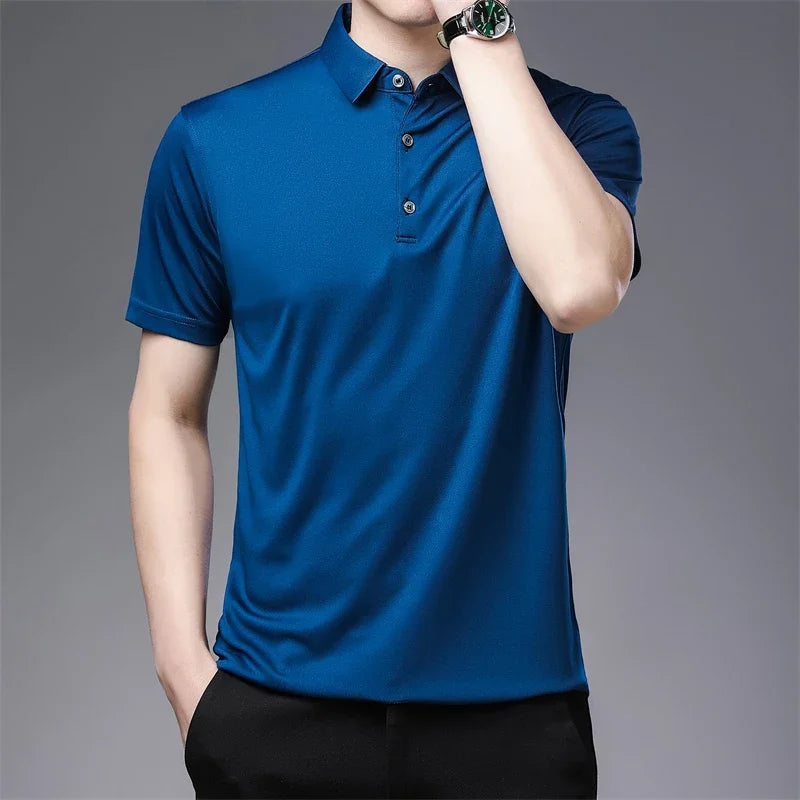 Person wearing a blue polo shirt on a gray background