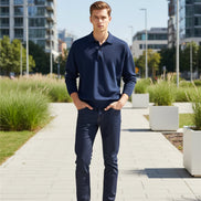Person wearing a navy blue sweater with a plain background