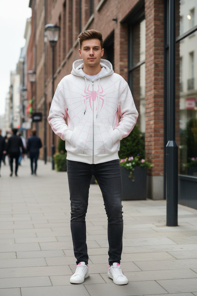 White hoodie with pink spider design on a textured gray background