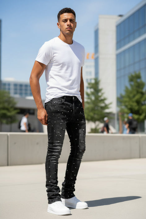 Black jeans with rhinestone embellishments on a white background