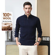 Man wearing a navy blue sweater with text about wool content on a minimal background