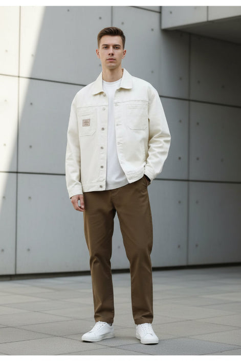 Beige denim jacket worn by a person on a white background