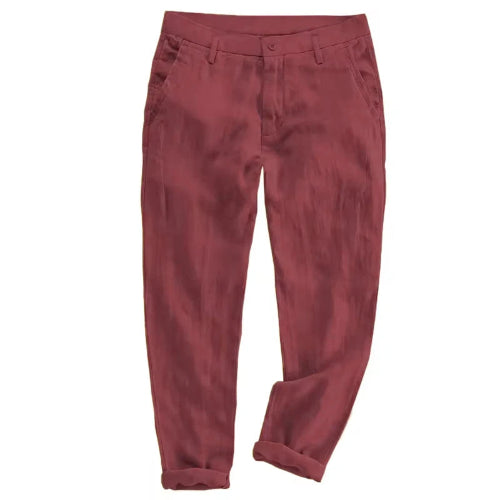 A pair of men's trousers in a dusty rose or muted brick red color, shown flat against a solid white background.