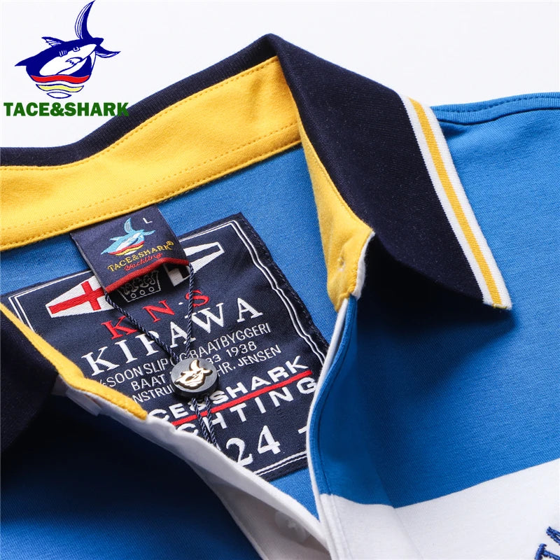Close-up of a blue, yellow, and white polo shirt collar with a visible TACE&SHARK brand neck label and logo printed on the fabric.