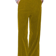A person wearing high-waisted, wide-leg mustard yellow corduroy trousers, styled with a light lavender ruffled shirt and black leather shoes, 