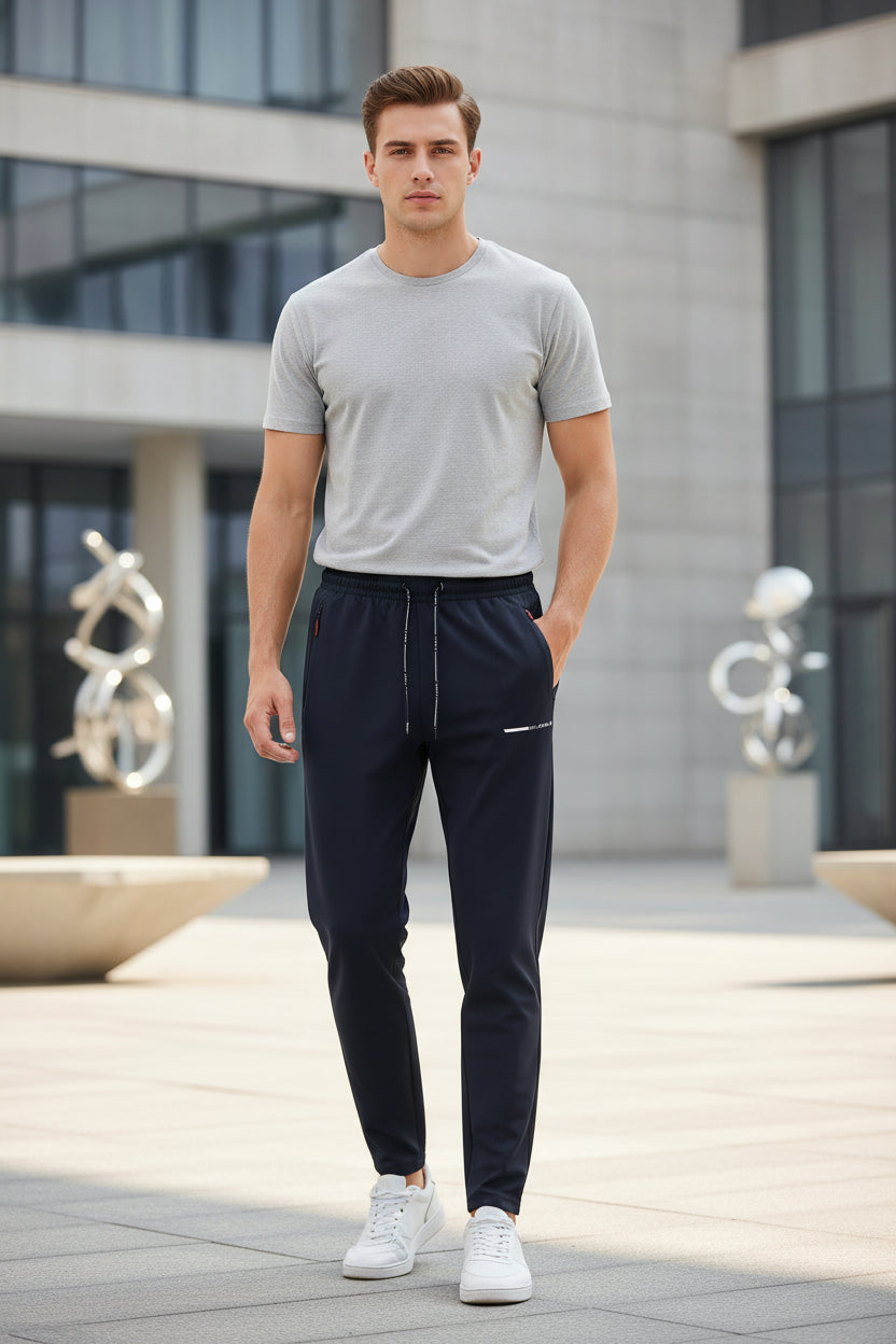 Black pants with a brand label on a light gray background