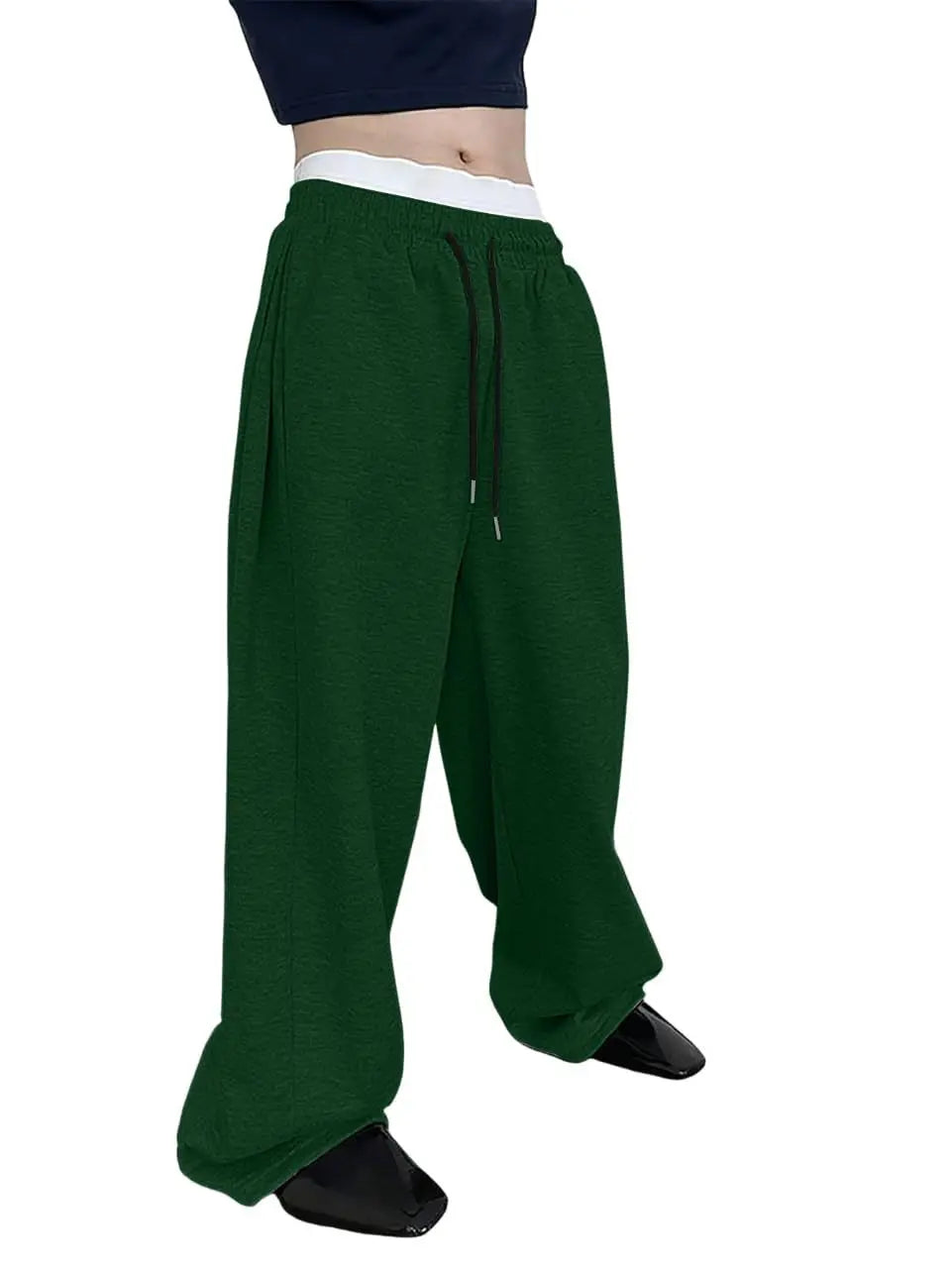 Green baggy pants worn by a person on a white background