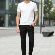 Person wearing black pants and brown shoes against a white background
