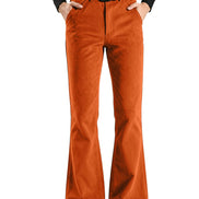 A pair of bright orange flared pants with a black belt, shown on a model wearing a black long-sleeve top and black shoes against a plain white background.
