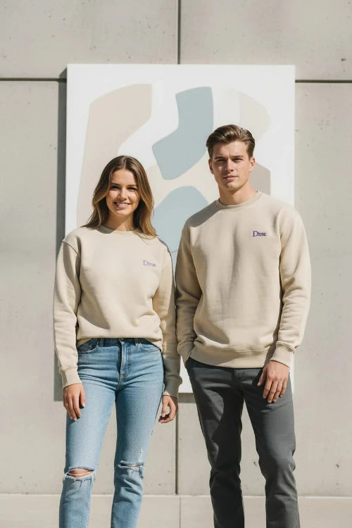 A beige crewneck sweatshirt with a small purple embroidered 'Dtime' logo on the left chest, displayed on a clean white background.
