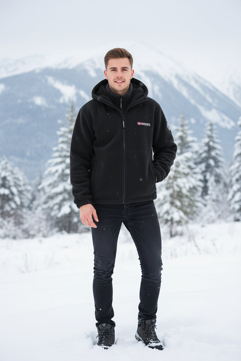 Black fleece jacket with brand logo on a gray background, featuring a flame graphic.