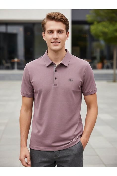 Purple polo shirt on a hanger with a hand touching it, brand logo visible