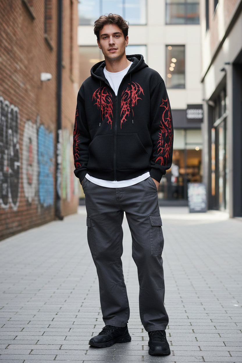 Black hoodie with red tribal designs on a light gray background