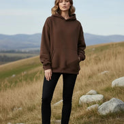 Brown hoodie worn by a person on a white background