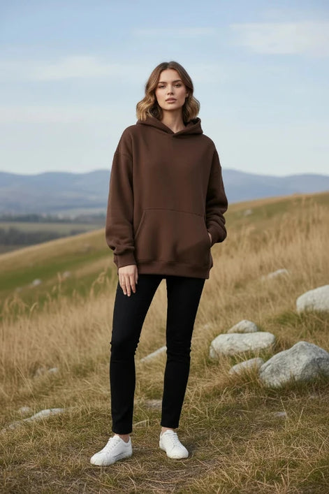 Brown hoodie worn by a person on a white background