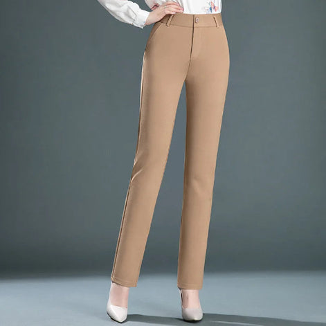 Beige pants worn by a person on a gray background