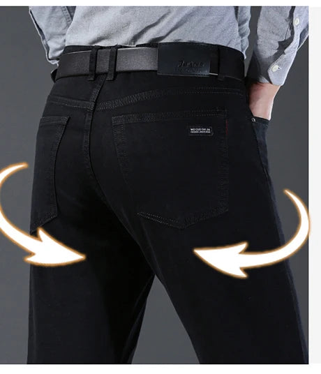 Black pants with a focus on the back pocket on a gray background