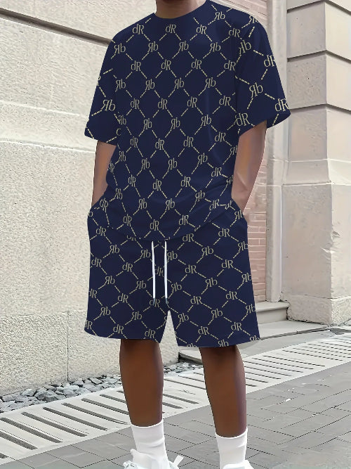 A person wearing a navy blue short-sleeve t-shirt and matching shorts set, both featuring a repeating beige monogram pattern. 