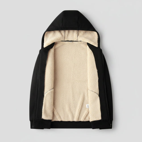 Black jacket with beige fleece lining on a beige textured background