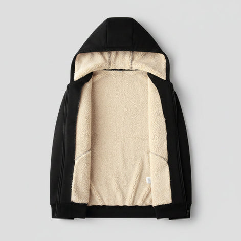 Black jacket with beige fleece lining on a beige textured background