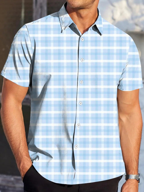 Man wearing a light blue checkered shirt with a blurred background