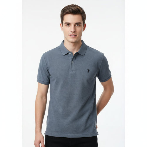 Gray polo shirt with a brand logo held by a hand, with more shirts in the background.