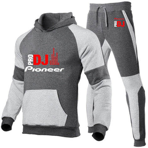 A two-piece athletic tracksuit set featuring a pullover hoodie and matching jogger pants. The set is primarily dark 
