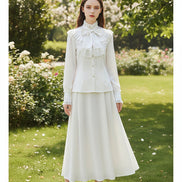 White blouse with lace details and a bow on a white background