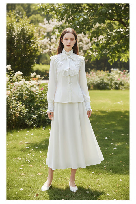 White blouse with lace details and a bow on a white background