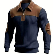 A men's long-sleeve quarter-zip pullover sweater with a navy blue ribbed body, brown collar and shoulder yoke, and brown elbow patches, shown on a plain white background.