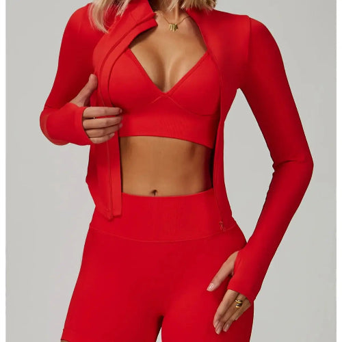 Person wearing a red outfit with a jacket and leggings on a gray background