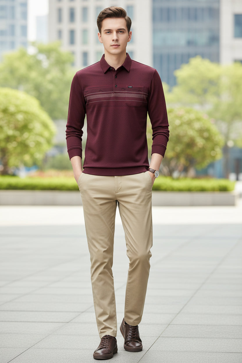 A man wearing a long-sleeve polo shirt in a deep burgundy red color, paired with beige trousers. The shirt features a textured pattern, a classic collar, a three-button placket, and horizontal stripe details across the chest.