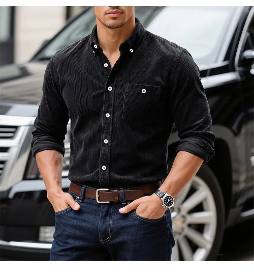 A man wearing a black long-sleeve button-down shirt with white buttons, 