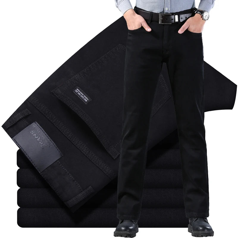 Person wearing black pants with a folded black jacket on a white background
