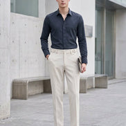 Person wearing beige textured pants with a blurred background