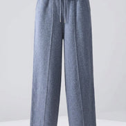A pair of relaxed-fit, wide-leg trousers in a heathered slate blue-gray fabric, 