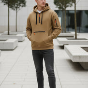 Beige hoodie with black and orange accents on a white background