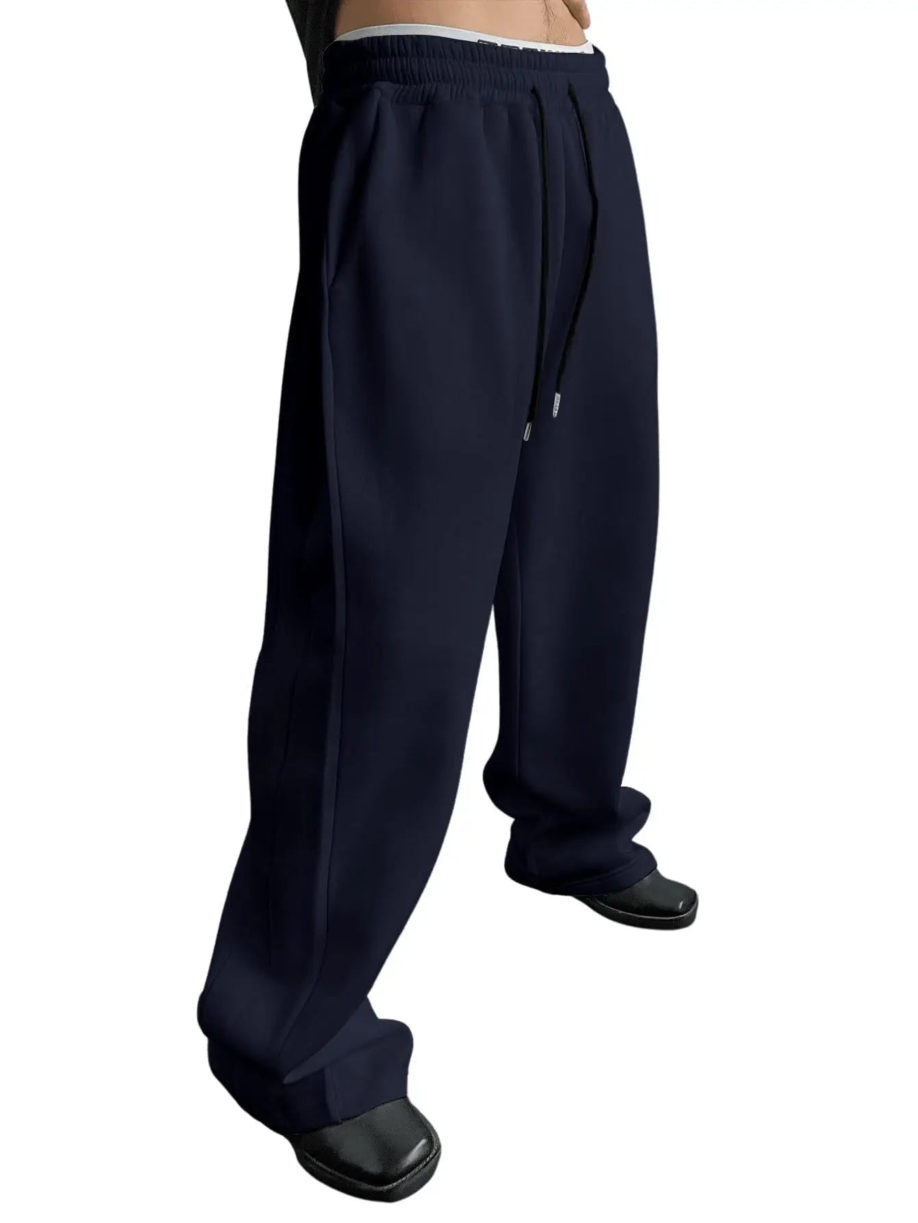 Navy blue pants worn by a person on a white background