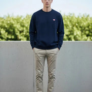 Navy blue sweatshirt with a small red logo on a white background