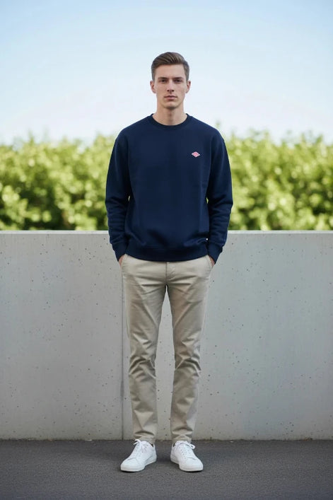 Navy blue sweatshirt with a small red logo on a white background