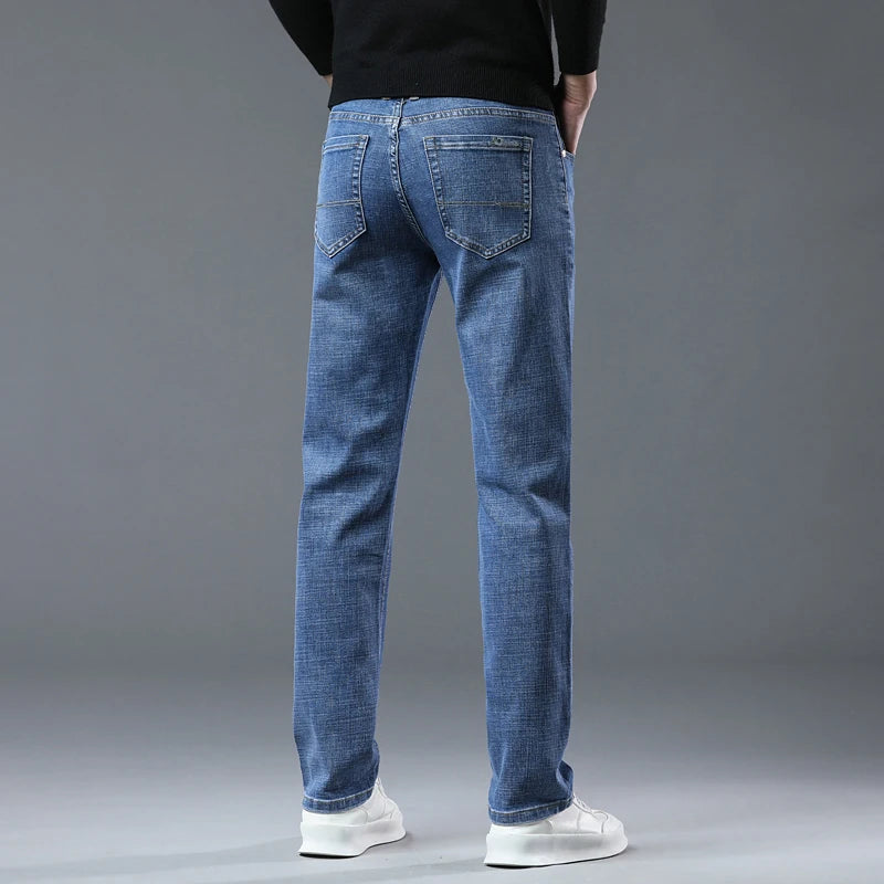Person wearing blue jeans on a gray background