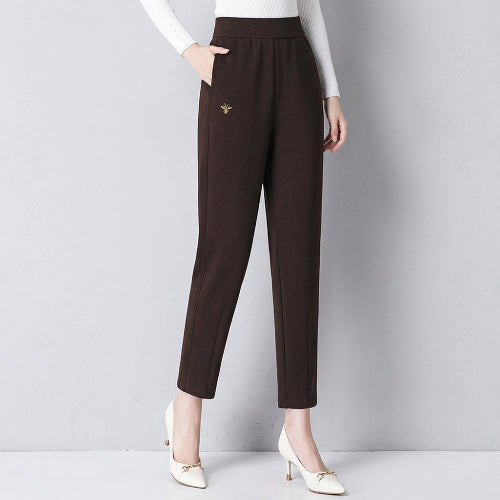 Dark brown pants worn by a person on a dark background