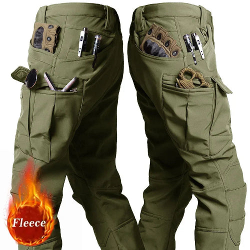 Two side views of olive green cargo pants showing large thigh pockets and smaller pockets holding gloves, tools, and accessories against a white background.