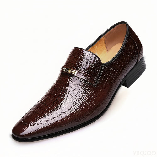 Brown crocodile-patterned loafer shoe on a white background