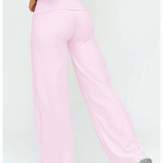 Person wearing pink pants on a light gray background