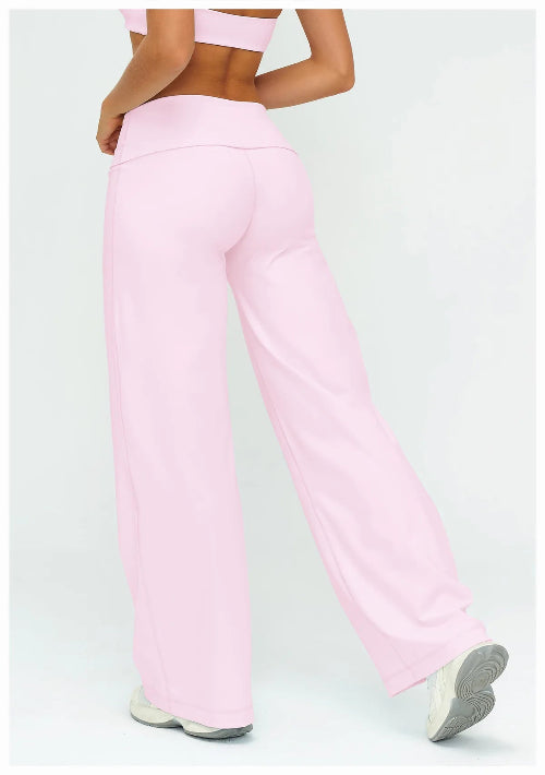 Person wearing pink pants on a light gray background