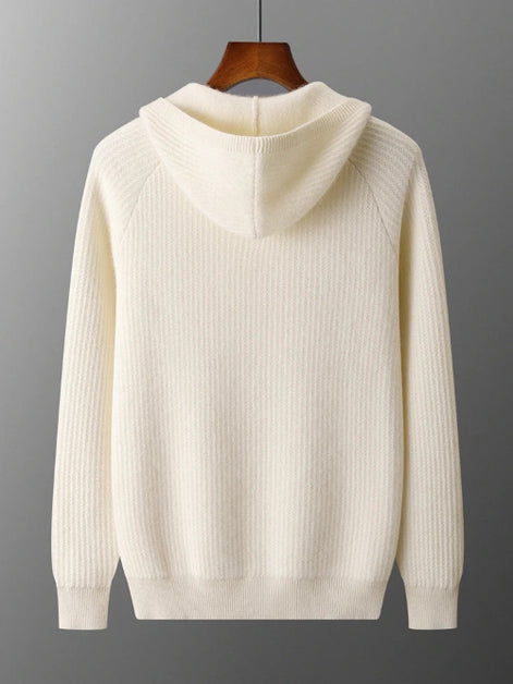 An off-white ribbed knit hooded sweater hanging on a wooden hanger against a dark gray gradient background.